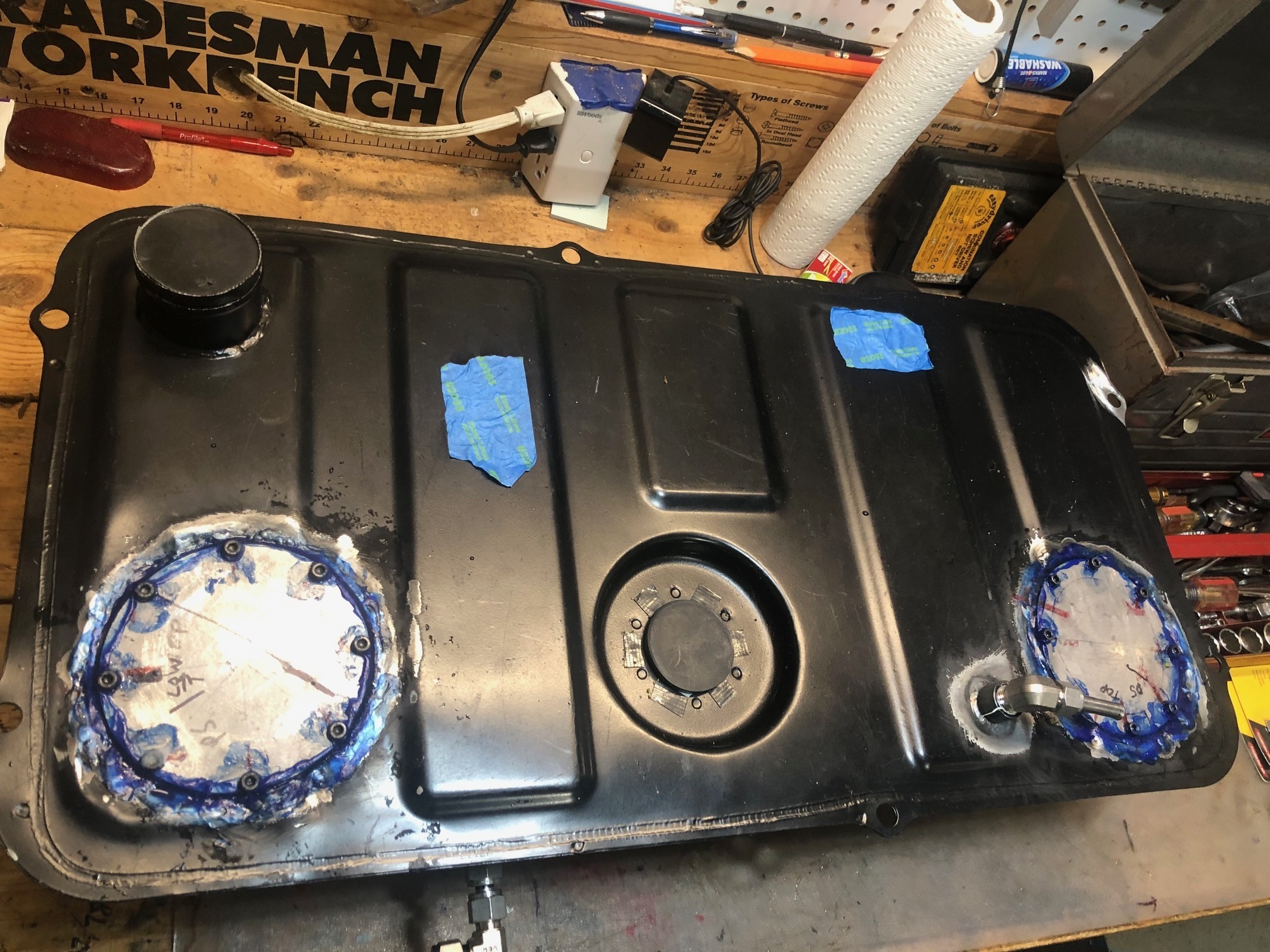 Fuel tank with supply and return line access flanges covered.